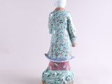 an image of a figurine of a woman in a blue dress