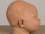 a clay head of a baby on a table
