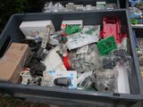 a bin full of assorted electronics and other items