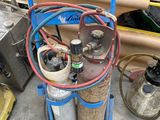 a cart with two cylinders and a hose on it