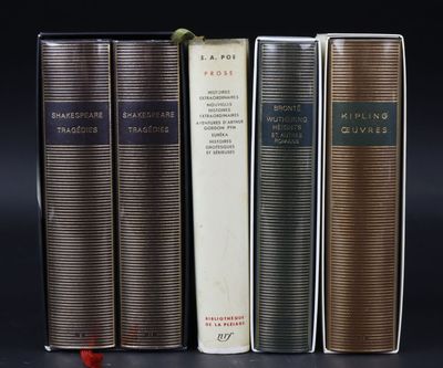 three books sitting on top of each other on a black surface