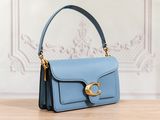 the small blue purse is sitting on a wooden table