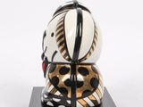 a close up of a sculpture of a zebra on a black base