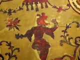 a close up of a painting on a gold plate