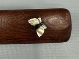a small wooden case with a butterfly on it
