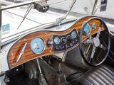 a steering wheel and dashboard of a car with a clock on it