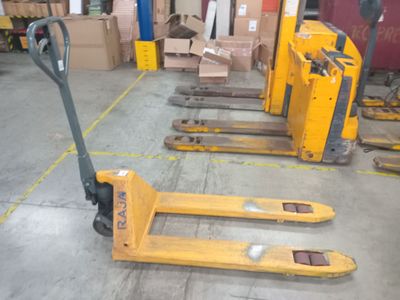 yellow forklifts in a warehouse with boxes and boxes in the background