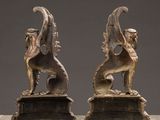 pair of bronze figurines of mythical animals on a marble base