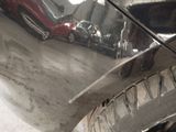 a close up of a shiny car with a red car in the background