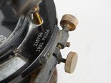 a close up of a compass on a white surface