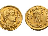 a gold coin with an image of a man holding a sword