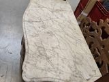 a table with a marble top in the middle of a room