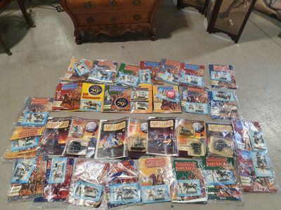 a lot of comic books on the floor next to a dresser