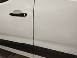 the door handle of a white van with a sticker on the side of it