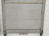 a white bed with a white headboard and foot board