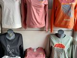 many shirts on display on a table in a store