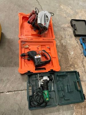 a tool box with a drill and other tools on the floor