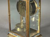 a clock that is sitting inside of a glass case