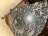 a black and white marble table in the corner of a room