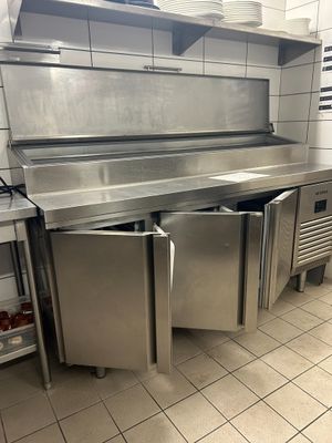 a large stainless steel kitchen with a sink and dishwasher