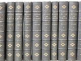 the books are lined up in rows on a white surface