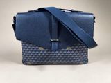 a blue and white bag with a blue strap on it