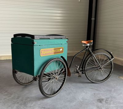 a bike with a cart attached to it in a garage