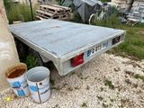 an image of a truck bed with a bucket of dirt