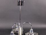 pair of silver plated candlesticks on a black table