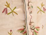 a close up of a pillow with a floral design on it