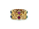 a close up of a gold ring with multi colored stones