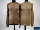 two women ' s sweaters sitting on a mannequin stand