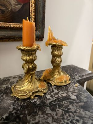 two candles that are sitting on a marble table