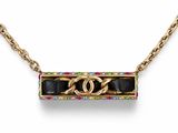 a necklace with a gold chain and a black and gold pendant