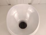 a white bowl with a hole in the middle of it