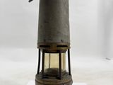 an old fashioned oil lamp on a white surface with a white background