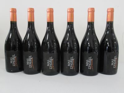 six bottles of wine are lined up in a row on a white surface