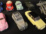 several toy cars are lined up on a black surface