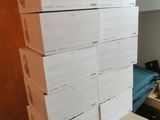 many boxes stacked on top of each other in a room