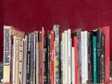 a cat that is sitting in front of a book shelf