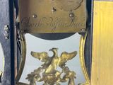 a clock that has a gold decoration on the front of it