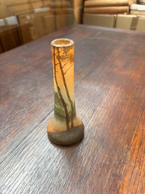 un petit vase sur lequel est représenté un arbre