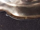 a close up of a metal object on a black surface