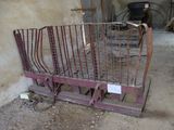 a metal bed in the middle of a dirty room