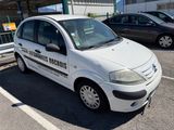 a small white car that is parked in a parking lot