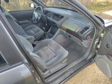 the interior of a car with the door open and the driver ' s seat up
