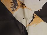 an image of a scarf with a picture of a man ' s face on it