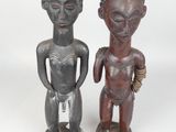pair of african carved wooden figures of a man and a woman