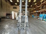 a forklift in the middle of a warehouse filled with pallets