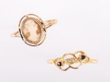 two gold rings and a ring with a picture of a woman ' s face